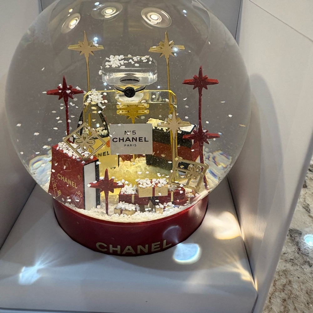 CHANEL Holiday Decor Snow Globe with Red and Gold Elegance